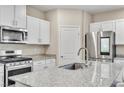 Bright kitchen features granite countertops, modern appliances, and white cabinetry at 4333 Glossier Ave, North Las Vegas, NV 89084