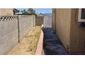 An outdoor area with block walls, and a gate providing access to the backyard at 5157 New Bedford Dr, Las Vegas, NV 89122