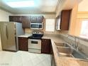 Updated kitchen with stainless steel appliances, granite counters, and double basin sink at 8101 W Flamingo Rd # 1044, Las Vegas, NV 89147