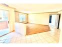 Bright living room featuring tile and wood flooring and access to a private balcony at 8101 W Flamingo Rd # 1044, Las Vegas, NV 89147