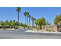 Well maintained community entrance with lush trees and desert landscaping at 8919 Don Valley Ave, Las Vegas, NV 89148