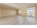 Spacious living room with large windows and a sliding door, offering plenty of natural light at 9737 Toad Hollow St, Las Vegas, NV 89141