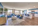 Bright living room featuring modern furniture, hardwood floors, and an open kitchen concept at 10382 Luna Mezzo St Ave # Lot 196, Las Vegas, NV 89141