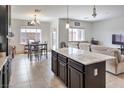 Open floor plan features a kitchen with granite countertops that flows into the living space at 10509 Hartford Hills Ave, Las Vegas, NV 89166