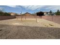Large backyard featuring gravel, a planting bed, and a brick wall surround at 108 Spur Ranch Ave, North Las Vegas, NV 89032