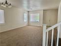 Bright living room with large windows, neutral carpet, and a double-door entry at 108 Spur Ranch Ave, North Las Vegas, NV 89032