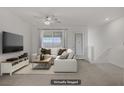 Spacious living room featuring a comfortable sofa, stylish decor, and ample natural light, virtually staged at 1103 Tektite Ave, Henderson, NV 89011