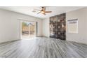 Spacious primary bedroom with stylish accent wall, ceiling fan, and sliding glass door at 1363 Yeager Ave, Las Vegas, NV 89123
