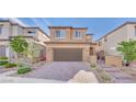 Attractive two-story home with a well-kept front yard, brick driveway, and a cozy entrance at 244 Native Stone St, Las Vegas, NV 89138