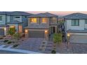 Beautiful two-story home featuring a paved driveway, desert landscaping, and a welcoming facade at 244 Native Stone St, Las Vegas, NV 89138