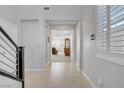 Inviting hallway with tile flooring, leading to a bright living space with shuttered windows at 2581 Tolmezzo St, Henderson, NV 89044