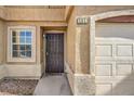 Inviting townhome entrance with secure front door and attached garage at 2620 Sierra Seco Ave # 101, Las Vegas, NV 89106