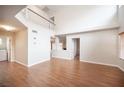 Bright living room features soaring ceilings, wood-look floors, and neutral paint, leading to other rooms at 3025 Yankee Clipper Dr, Las Vegas, NV 89117