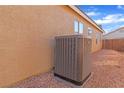 Side exterior view of the property showcasing the AC unit in a low-maintenance backyard at 3741 Round Robin St, North Las Vegas, NV 89032