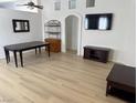 Bright and airy living room featuring wood-look floors and modern entertainment setup at 3741 Round Robin St, North Las Vegas, NV 89032