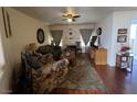Comfortable living room featuring a ceiling fan, hardwood floors, and a decorative fireplace, perfect for relaxing at 4555 E Sahara Ave # 166, Las Vegas, NV 89104
