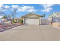 Single story home featuring a two-car garage and well-kept landscaping at 4623 Kearney St, Las Vegas, NV 89147