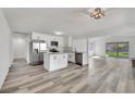 Contemporary kitchen with stainless appliances, center island, and light gray wood-look flooring at 4623 Kearney St, Las Vegas, NV 89147
