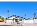 Charming single-story home featuring a two-car garage, palm trees, desert landscaping, and a white stucco facade at 4774 San Sebastian Ave, Las Vegas, NV 89121