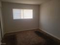 Carpeted bedroom with a window providing natural light at 5248 Greene Ln # B, Las Vegas, NV 89119