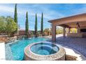 Wonderful pool and spa with water features and covered patio area, perfect for outdoor entertaining at 5410 Serenity Brook Dr, Las Vegas, NV 89149