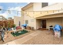 Charming front yard featuring gravel landscaping, patio seating, and string lights at 555 Rene Ln, Henderson, NV 89015