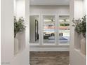 Hallway with decorative niches, wood floors, and views of the backyard patio and pool through large windows at 5865 Egan Crest Dr, Las Vegas, NV 89149