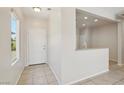 Inviting foyer with tile flooring and an open view into the kitchen, creating a seamless transition at 6059 Wheat Penny Ave, Las Vegas, NV 89122