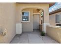 A close-up of the entryway showcases an arched entrance and unique door with a security screen at 6059 Wheat Penny Ave, Las Vegas, NV 89122