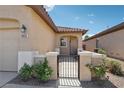 A charming front porch provides a welcoming entrance to the home, complete with a gated courtyard at 6059 Wheat Penny Ave, Las Vegas, NV 89122