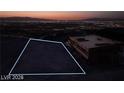 Aerial view of a vacant lot showcasing city lights and mountain views at night at 611 Grand Rim Dr, Henderson, NV 89012