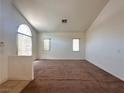 Spacious living room features ample natural light and neutral carpeting at 632 Hitchen Post Dr, Henderson, NV 89011