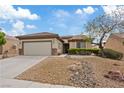 Attractive single-story home featuring a well-maintained desert landscape and neutral color scheme at 7452 Chaffinch St, North Las Vegas, NV 89084