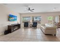 Bright living room with large windows, tile flooring, and neutral wall color at 7452 Chaffinch St, North Las Vegas, NV 89084