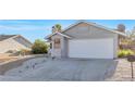 Single-story home with attached two-car garage, concrete driveway and white rock landscaping at 823 Crabapple Dr, Henderson, NV 89002