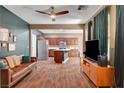 Spacious living room open to kitchen with tile floors and a ceiling fan at 8560 Alocasia Ct, Las Vegas, NV 89149