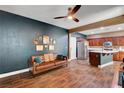 Living room open to kitchen featuring hardwood floors and stylish furnishings at 8560 Alocasia Ct, Las Vegas, NV 89149