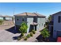 Two-story home boasts neutral stucco, tile roof, xeriscape landscaping, and a brick driveway at 8710 Beverly Grove Ct, Las Vegas, NV 89113