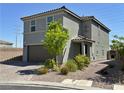 Beautiful two-story home boasts desert landscaping, a two-car garage, and a neutral color palette at 8710 Beverly Grove Ct, Las Vegas, NV 89113