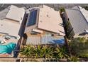 Aerial view of a home with a tile roof, solar panels, backyard patio, and swimming pool at 9785 Gallo Dr, Las Vegas, NV 89147