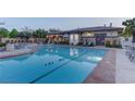 Resort style pool with clear blue water, concrete surround and table and chair seating at 10422 Prairie Mountain Ave, Las Vegas, NV 89166