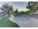 Community spa surrounded by artificial turf and lush landscaped planters at 10422 Prairie Mountain Ave, Las Vegas, NV 89166