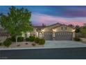 Charming single-story home featuring a stucco facade, well-manicured landscaping and a three-car garage at 11763 Kingsland Ave, Las Vegas, NV 89138