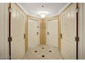 Hallway with two unit doors, tiled floors and ceiling light at 125 E Harmon Ave # 1620, Las Vegas, NV 89109