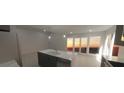 Modern kitchen with stainless steel appliances, an island with a sink, and access to outdoor views at 1280 S Yosemite Ave, Pahrump, NV 89048