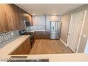 Spacious kitchen with stainless steel appliances, quartz countertops, gray cabinets, and white door at 150 N Las Vegas Blvd # 2302, Las Vegas, NV 89101