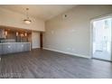 Bright living room with open floor plan and kitchen view, featuring hardwood floors and sliding glass door at 150 N Las Vegas Blvd # 2302, Las Vegas, NV 89101