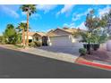 An inviting home featuring desert landscaping, a three-car garage, and a tile roof at 1594 Pontine Ct, Henderson, NV 89052