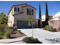 Charming two-story house with well-maintained landscaping and a driveway leading to the garage at 2381 Lilac Cove St, Las Vegas, NV 89135