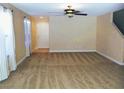 Bright living room with carpet flooring, fan, and a front door at 2381 Lilac Cove St, Las Vegas, NV 89135